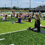 Students Practice Yoga on the Field