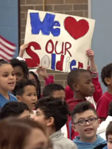 Students with red white and blue signs